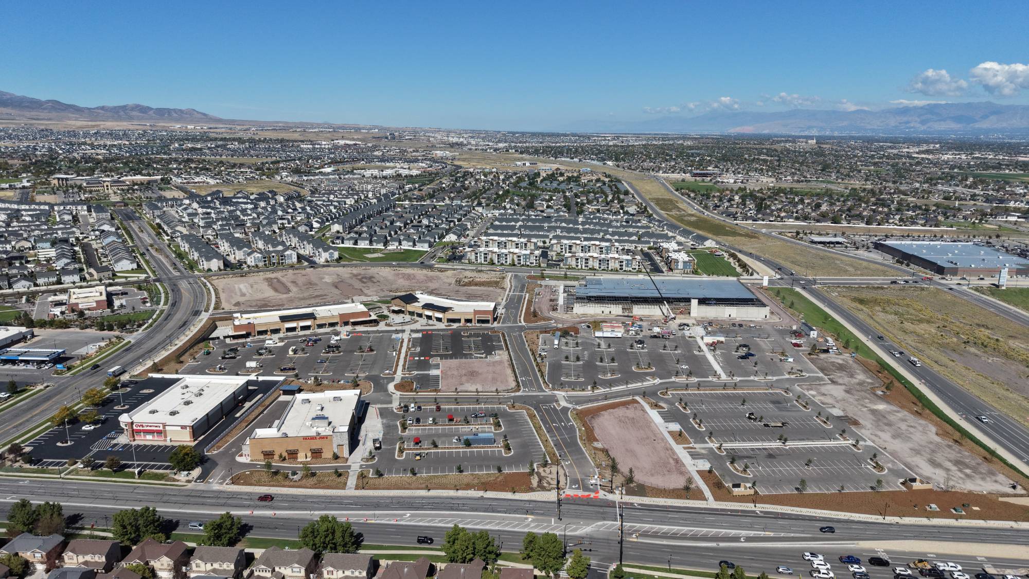 Wide aerial of The Commons looking across the parking field toward the Salt Lake valley