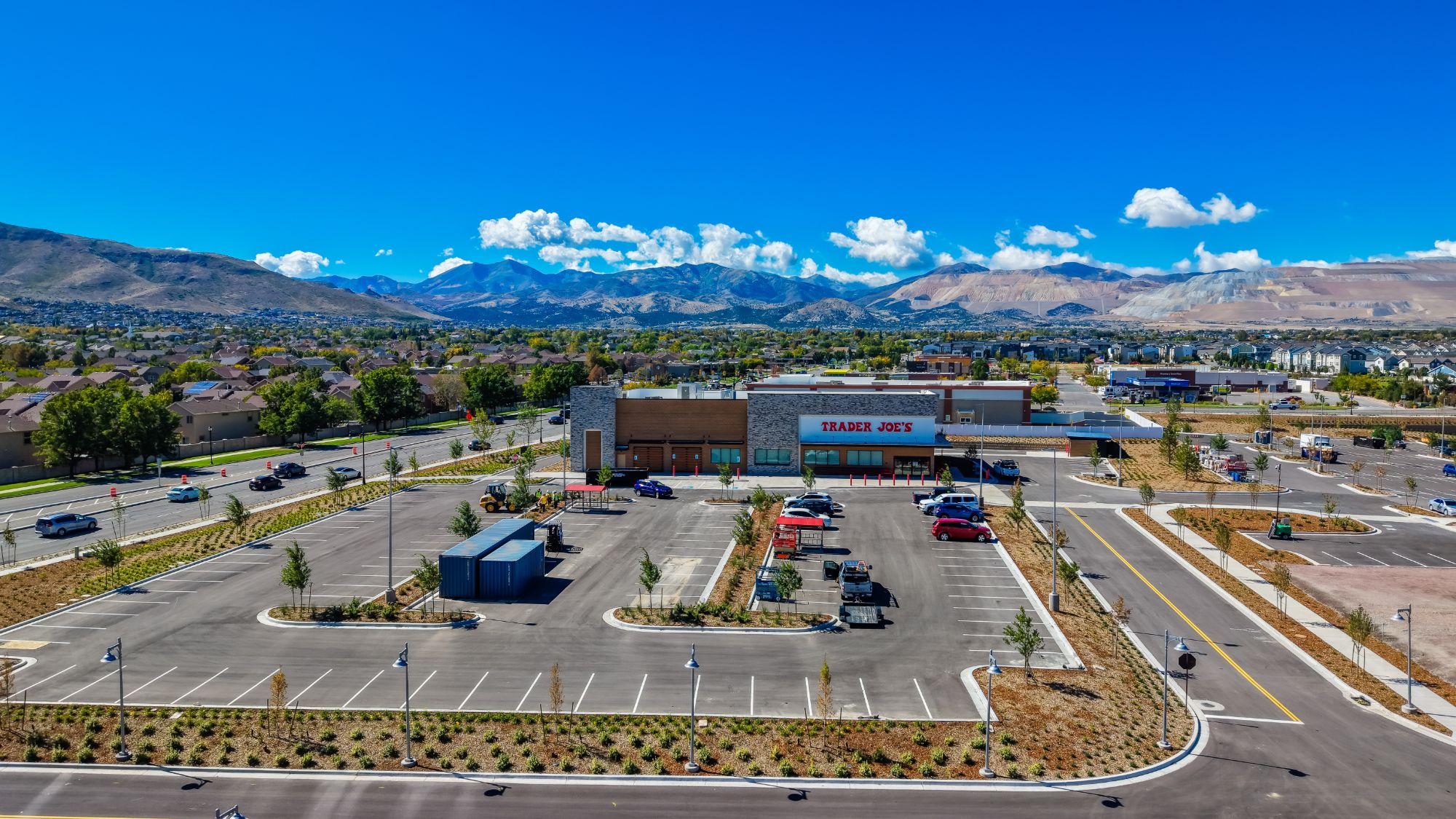 Aerial view of Trader Joe's and the parking field at The Commons with a wide mountain backdrop